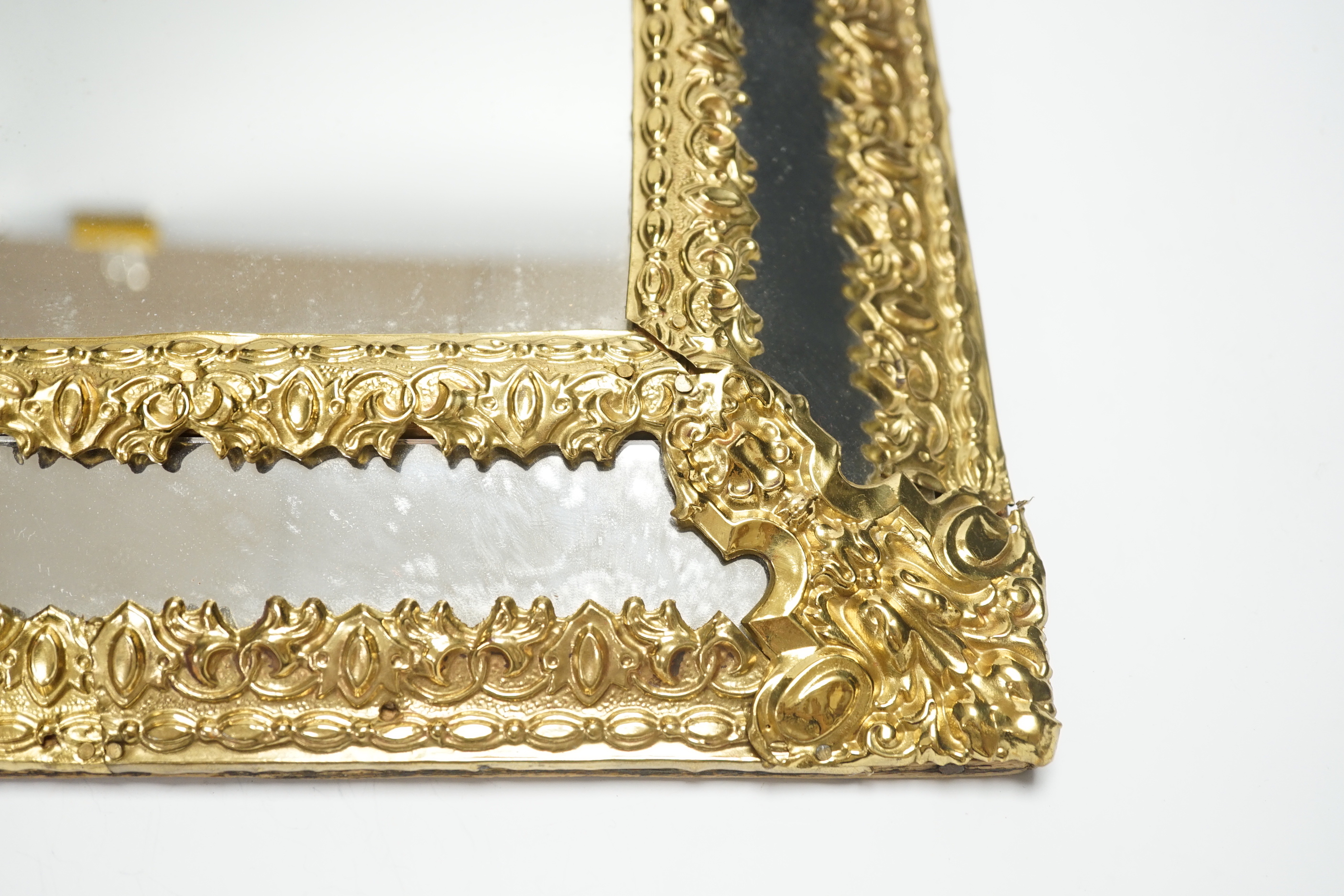 An 18th century-style embossed brass mirror, 58cm high